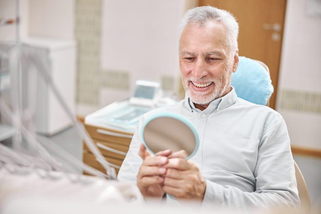 Aging gentleman sitting in a dental chair