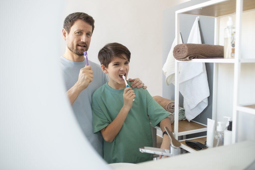 side-view-man-boy-brushing-teeth